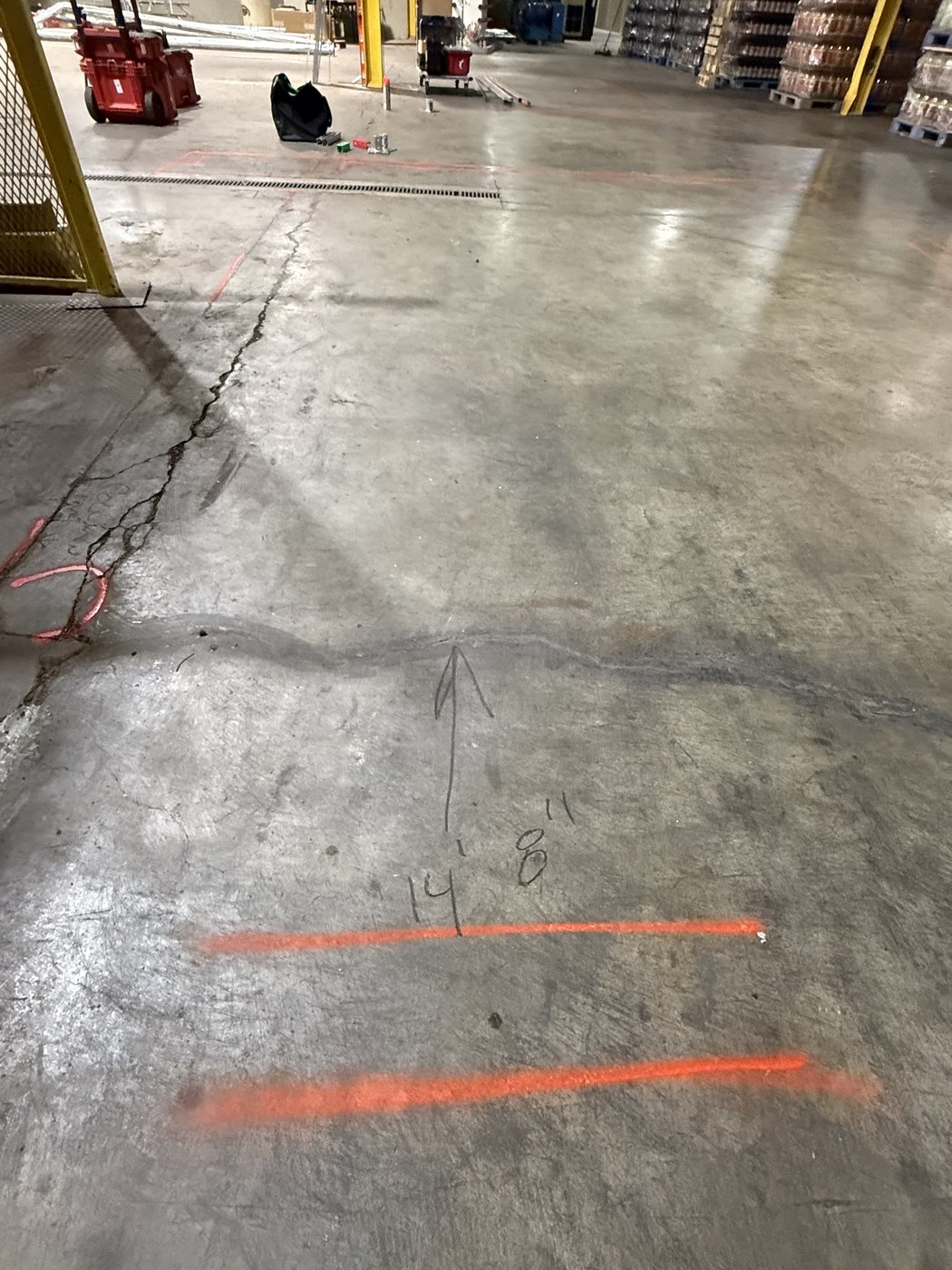 Cracked, worn concrete in the can-line footprint before the rebuild