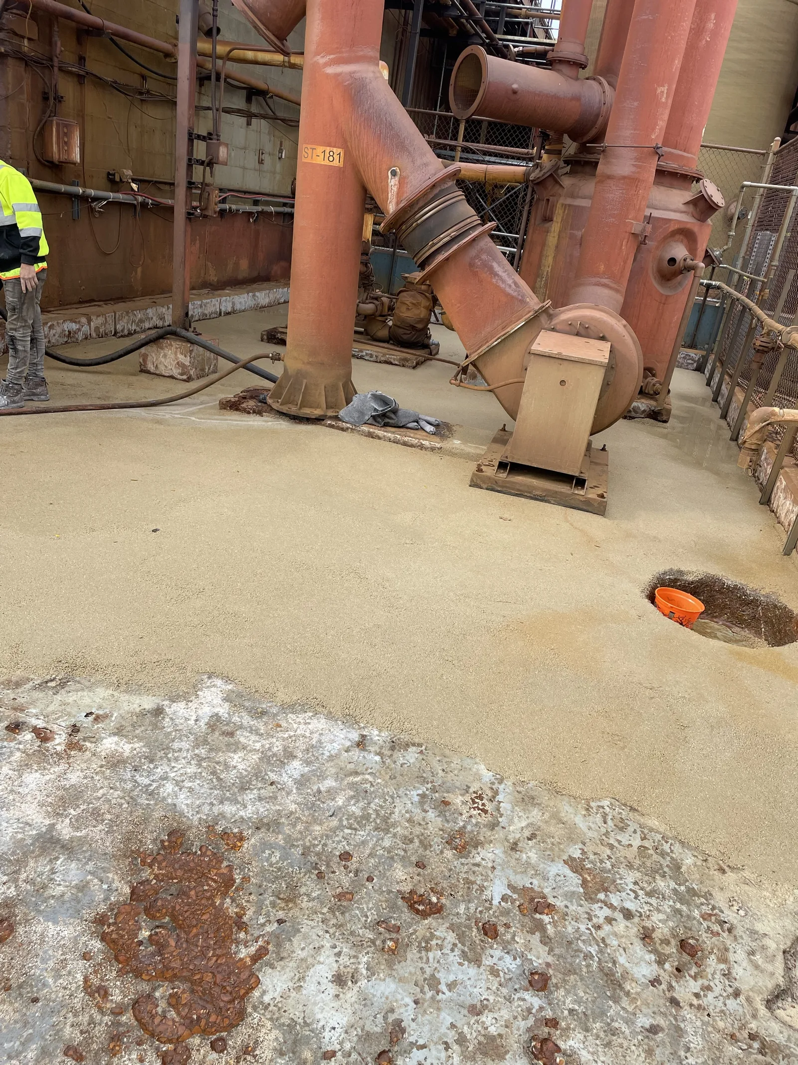 Broadcast lining being installed around pump bases on a containment pad