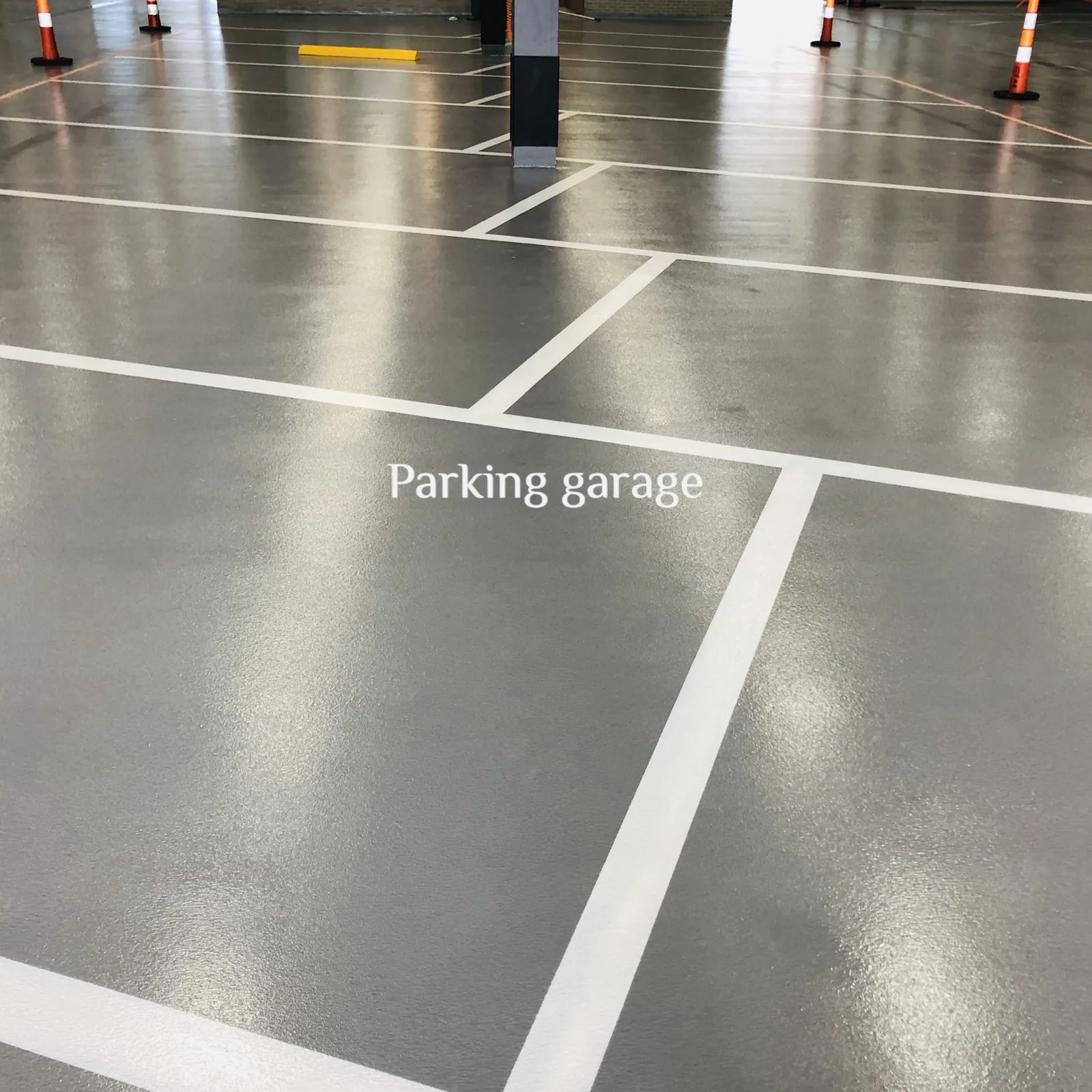 Grey broadcast parking deck coating with white striping