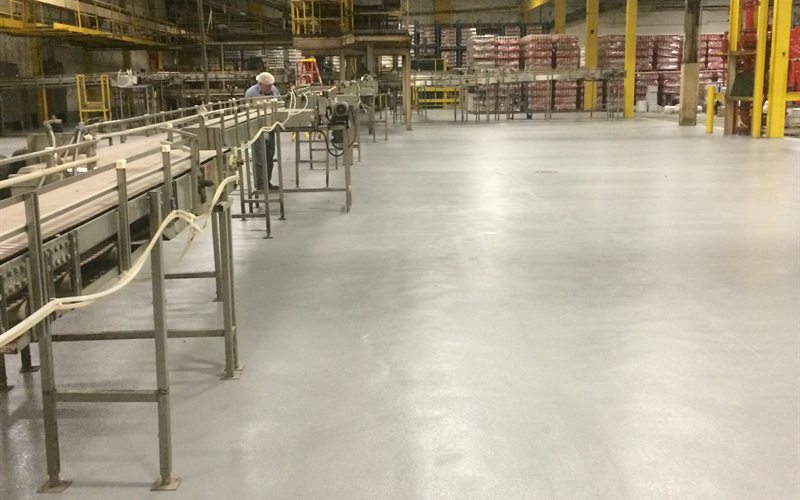 Beverage processing plant with a seamless MavCrete UM urethane mortar floor along the filler line